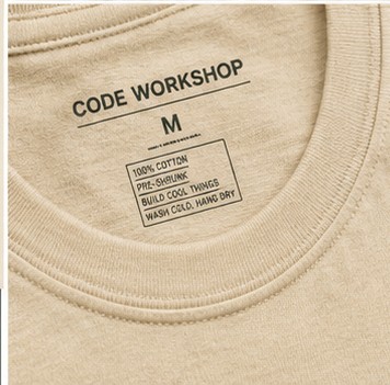 Custom printed neck label reading Code Workshop with care instructions
