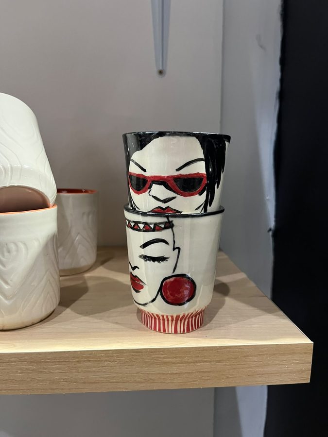 Hand-painted ceramic vessels with faces wearing sunglasses and red lipstick
