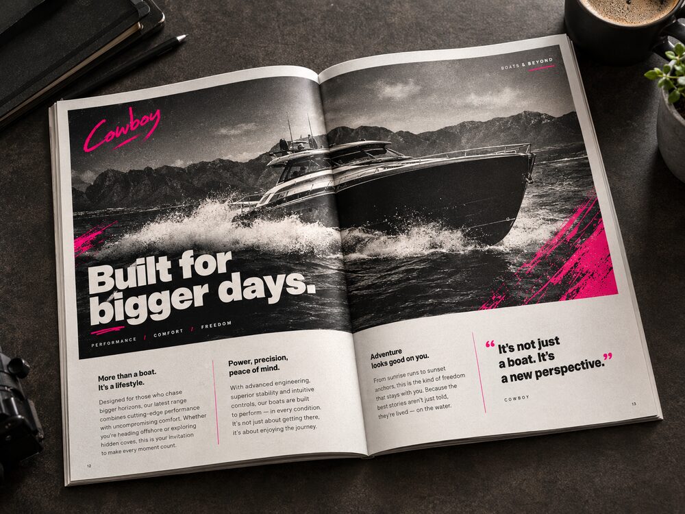An open magazine spread headed Built for bigger days, a boat photographed across the gutter with body columns and a pull quote